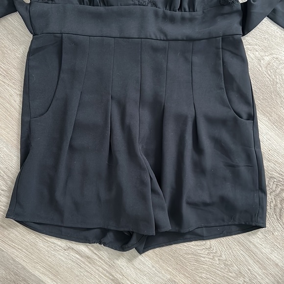 Black pleated front romper with lace trim sleeves and neck line - Picture 4 of 10